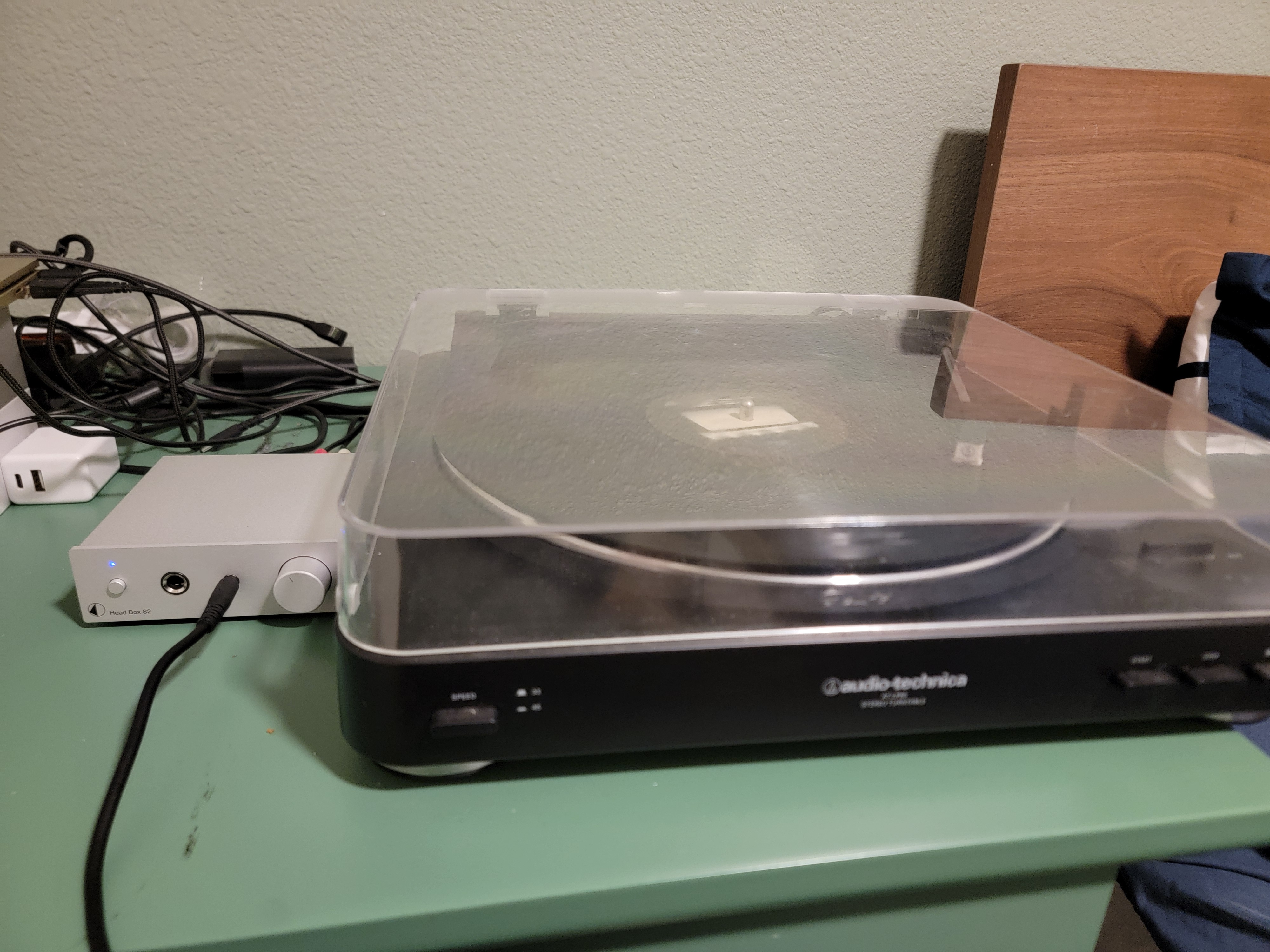 My current vinyl setup, an Audio-Technica LP60 with a Head Box S2 on my messy ass desk.